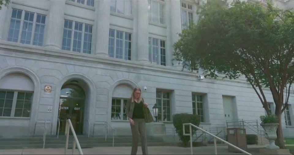 Colleen walking down the steps of the Ouachita Parish Courthouse